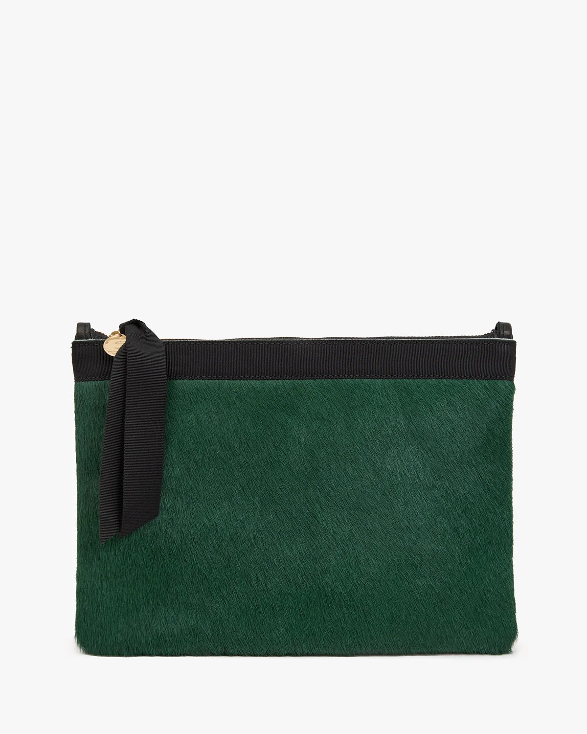 Clare V. Flat Clutch Bottle Green in a flat, rectangular shape made of bottle green hair-on leather with a black top border and a black ribbon tied to the gold zipper pull.