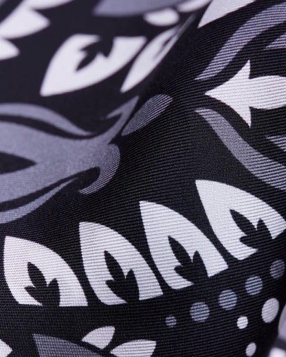 Close-up of the Maison Lecomte Flament Black scarf’s black and ivory bandana print.