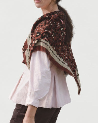 Maison Lecomte Flament Leo Chocolate Rosy scarf draped over a pale pink top.
