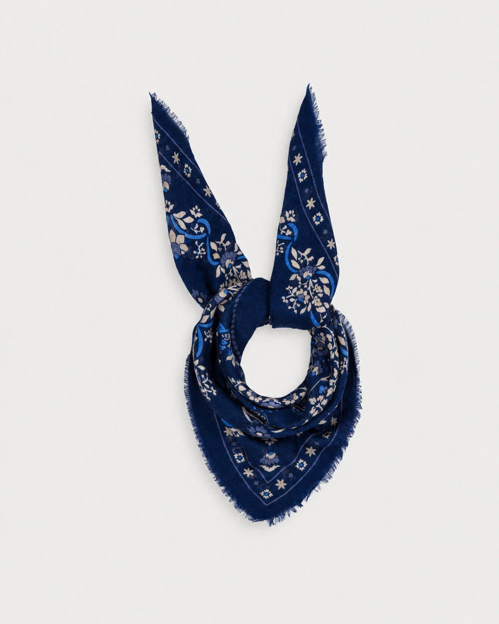 Maison Lecomte Flament Secret Garden Dark Navy scarf tied in a knot on a white background.