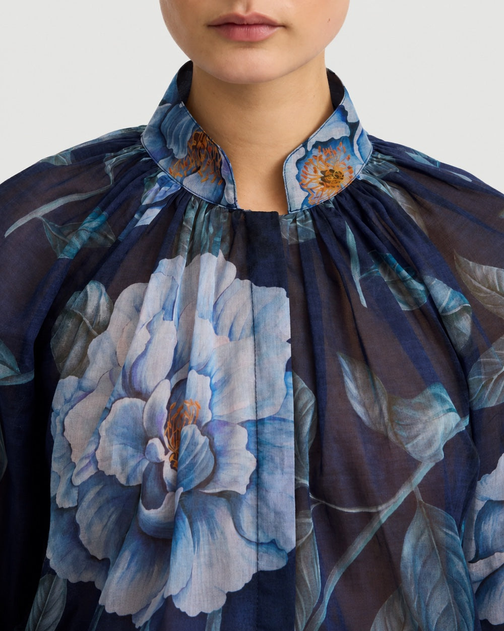 Smythe Gathered Blouse Navy Floral in navy blue with a high, gathered neckline and a large blue floral print.