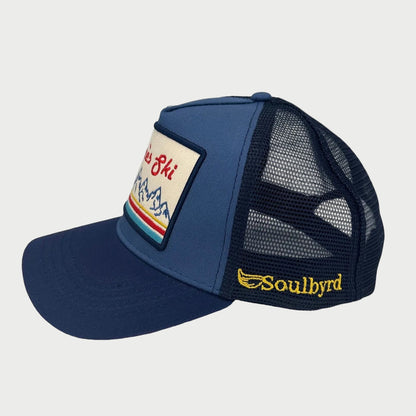 Navy blue trucker cap with mesh back and embroidered logo on a white background