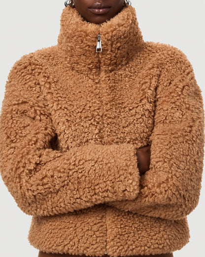 Close-up of APPARIS Brooks Coat in Camel showing curly faux shearling and zip collar