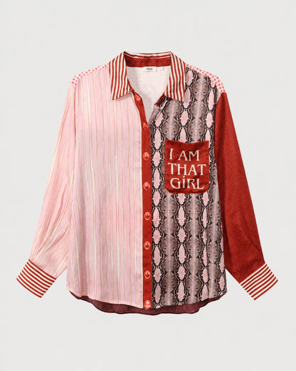 ME369 Isabel Shirt Red Aura with long sleeves and a mixed print of pink and white stripes, red polka dots, and a snakeskin pattern, featuring “I AM THAT GIRL” printed on the chest pocket.