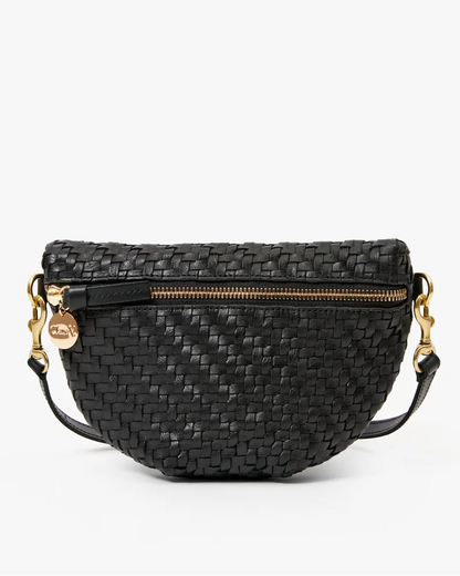 Clare V. Petite Fanny Black handwoven leather bag featuring a gold zipper and a circular gold charm on the side.