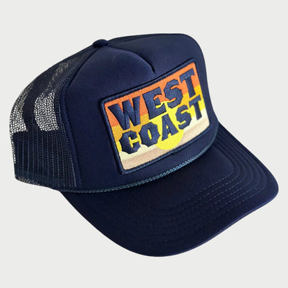 Navy blue trucker hat with 'West Coast' patch on a white background