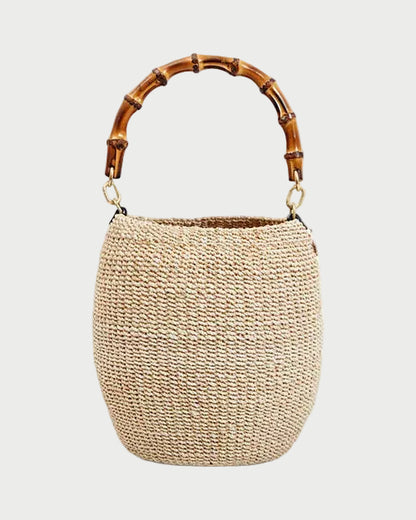 Woven handbag with bamboo handle on a white background