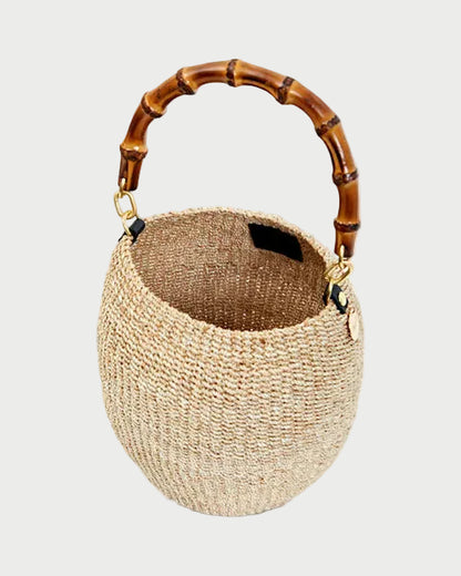 Woven handbag with bamboo handle on a white background