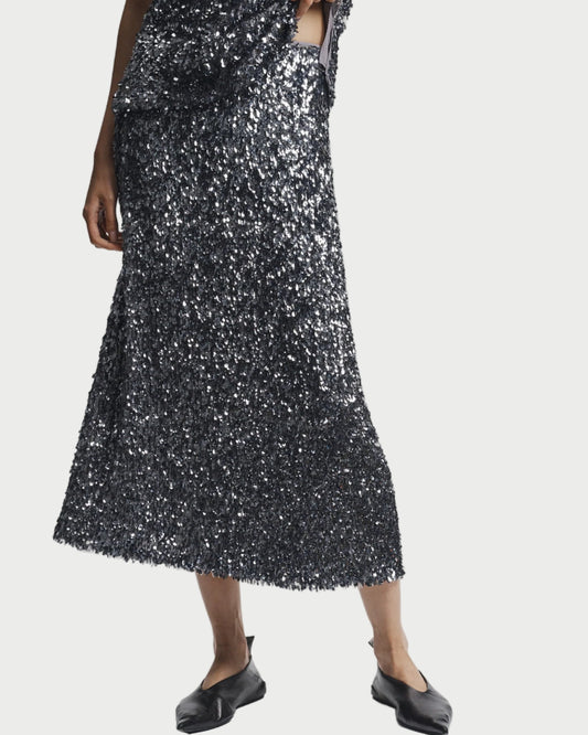 Person wearing a black sequin dress on a white background