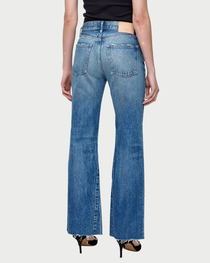 Person wearing blue jeans on a white background