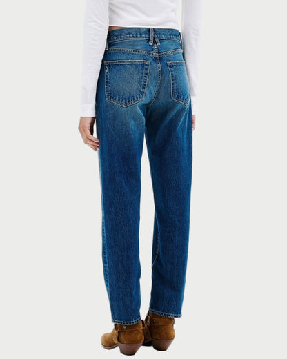 Person wearing blue jeans and a white shirt on a white background