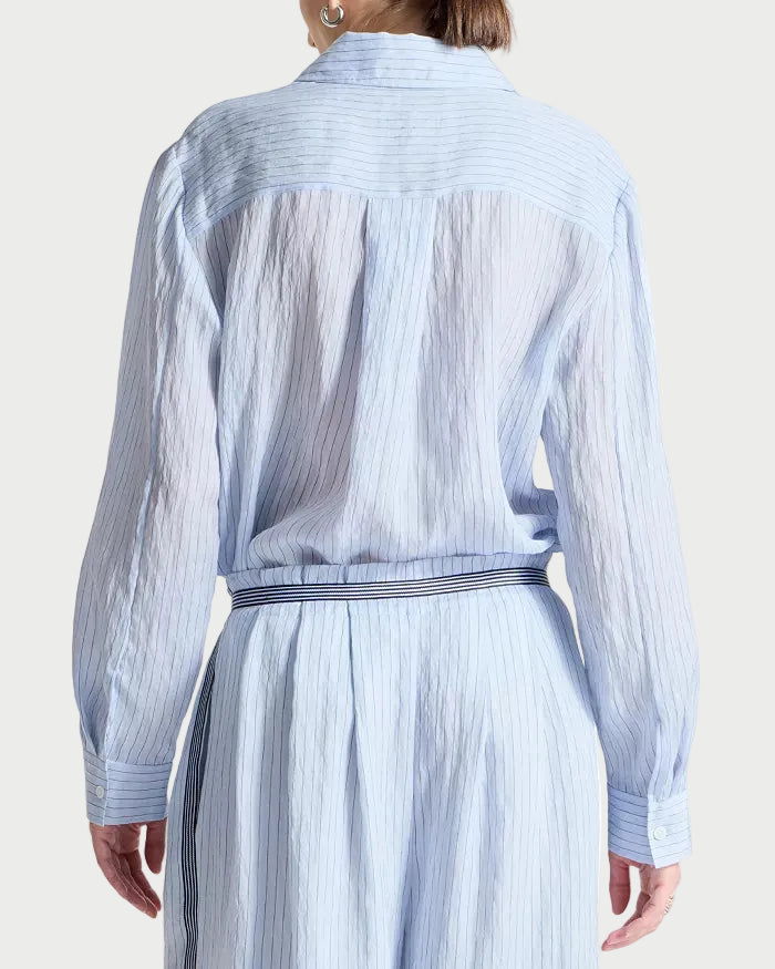 Light blue striped shirt with a belt on a white background