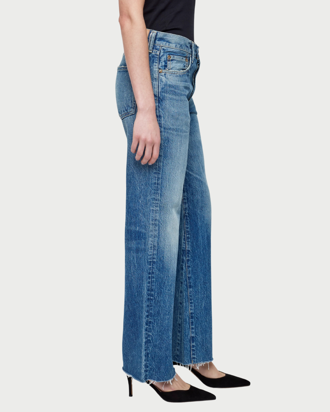 Blue jeans worn by a person on a white background
