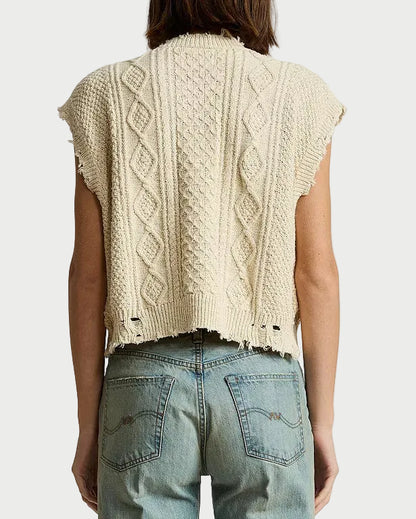 A person shown from the back wearing a cream cable-knit cropped sleeveless sweater and light blue jeans against a plain white background.