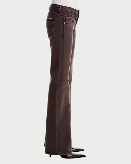 A pair of dark brown flared jeans shown from the side on a mannequin, paired with black pointed-toe heels against a plain white background.