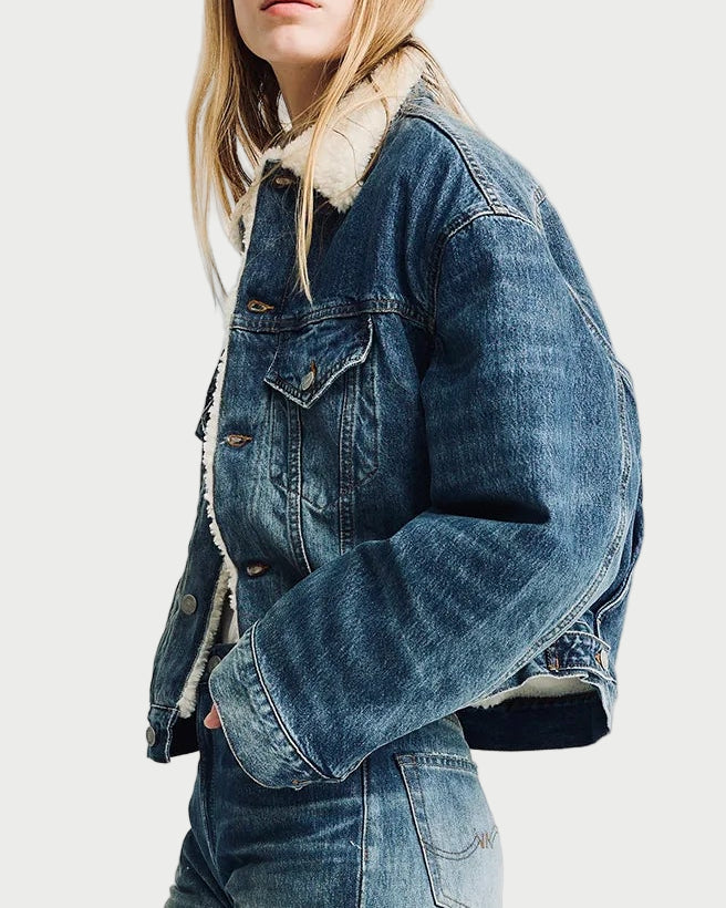 Person wearing a denim jacket and jeans on a white background