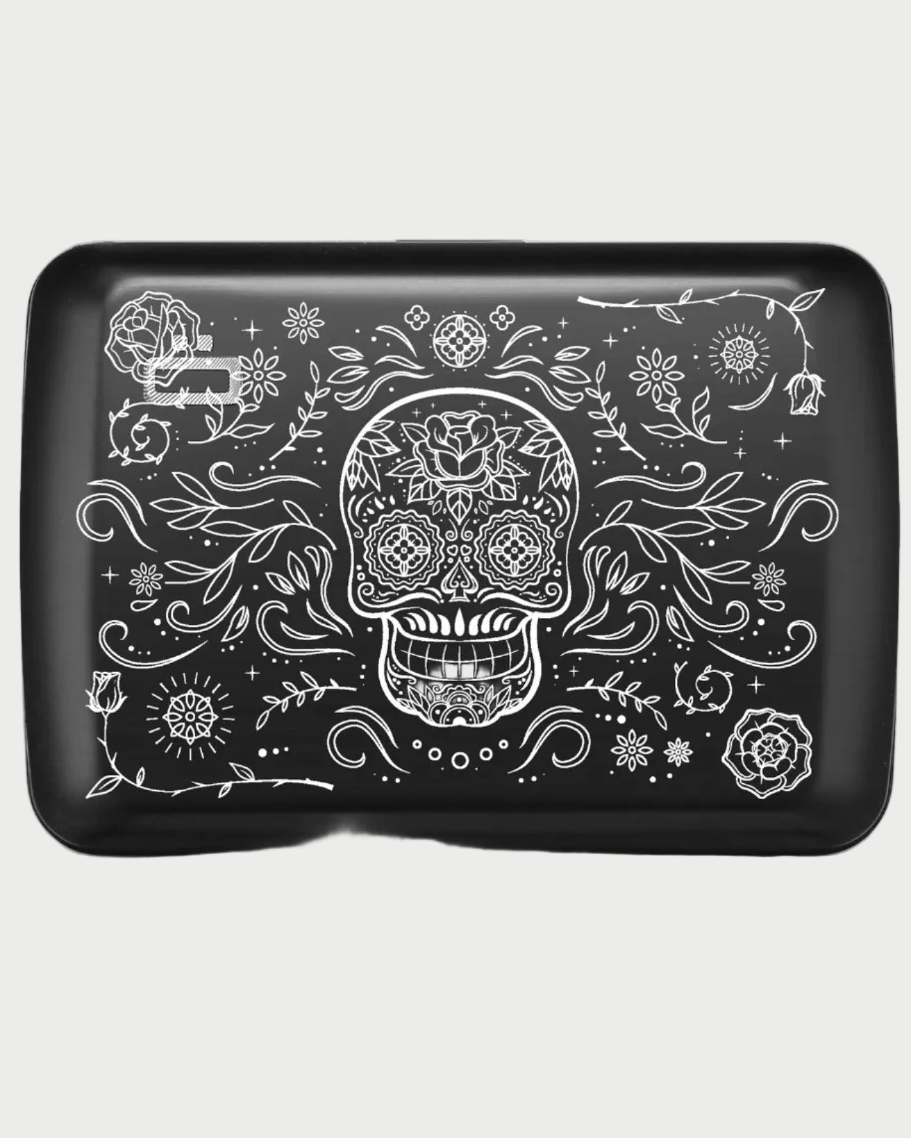Black rectangular device with white skull and floral design on a white background