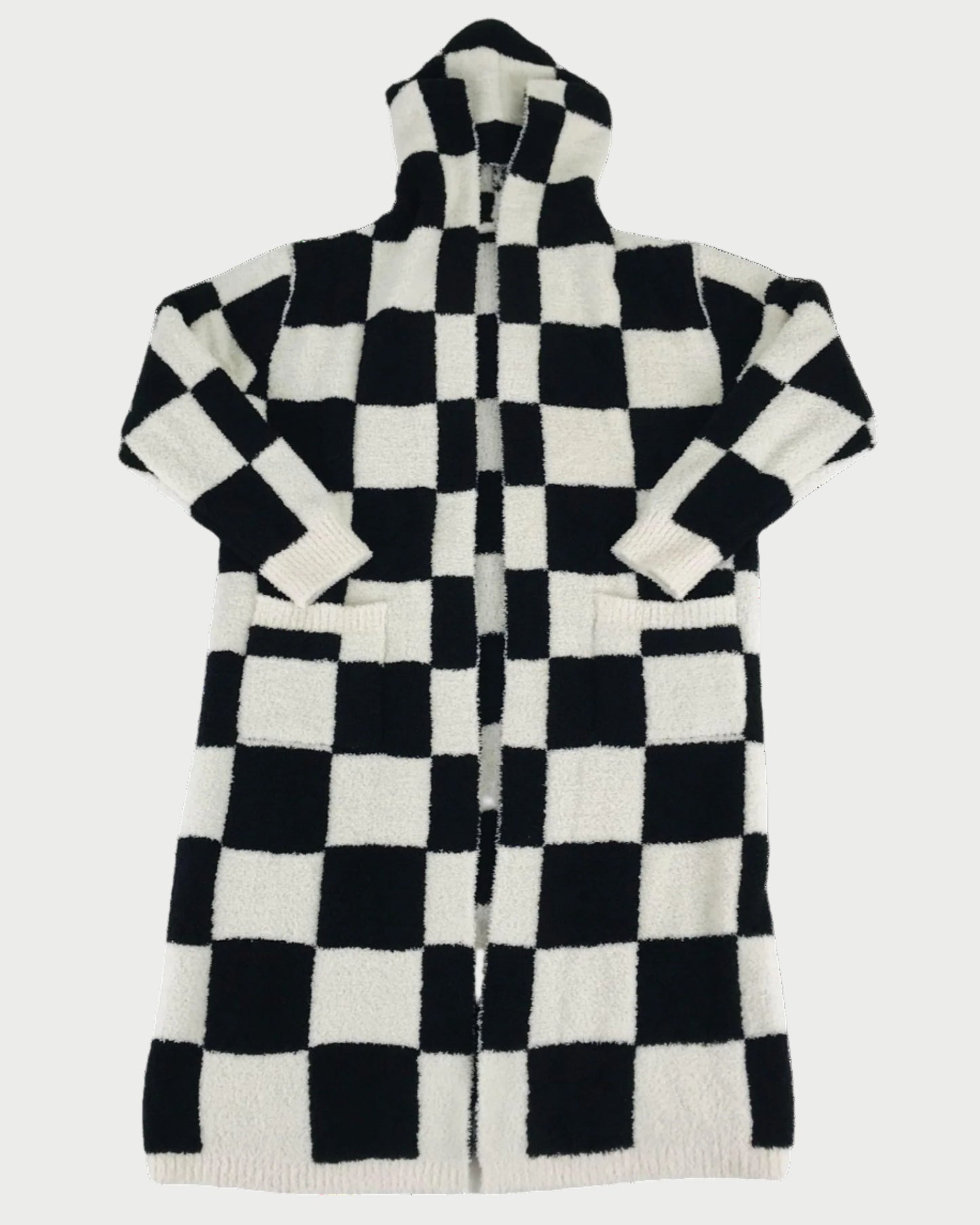 The LOCAL BEACH Black Checker Luxe Robe is a long, hooded robe with a black and white checkerboard pattern, front pockets, and long sleeves—perfect for cozy lounging on any relaxing day.