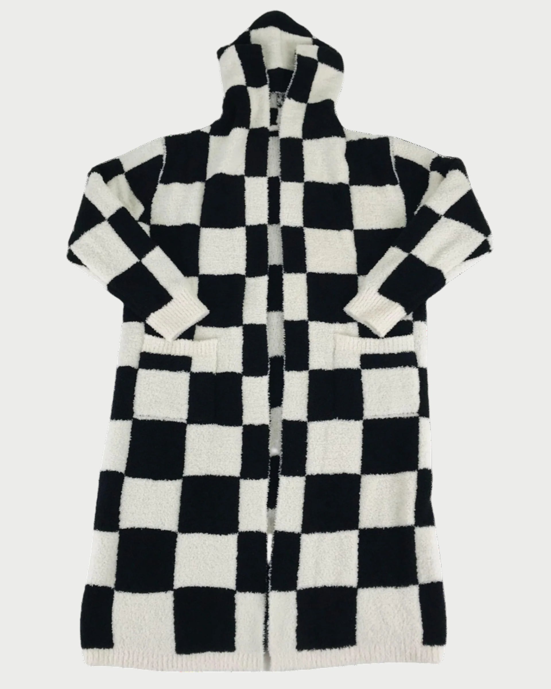 The LOCAL BEACH Black Checker Luxe Robe is a long, hooded robe with a black and white checkerboard pattern, front pockets, and long sleeves—perfect for cozy lounging on any relaxing day.