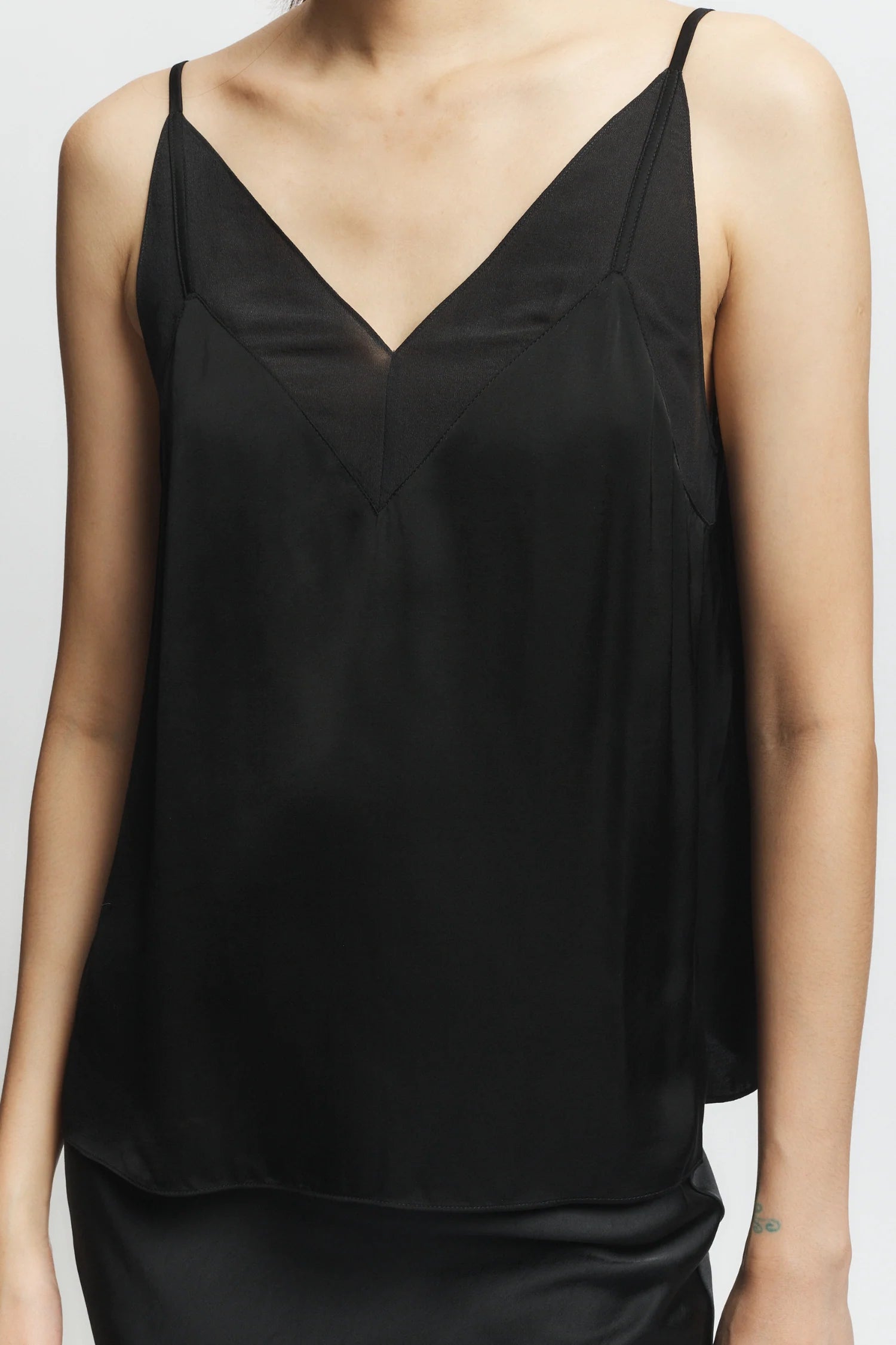 Black satin camisole on a plain background