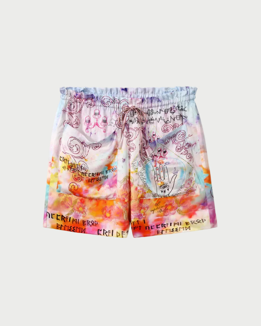 The ME369 Kori Shorts feature a vibrant tie-dye in pink, orange, yellow, and blue with black hand-drawn designs—hands, faces, swirls—and "CRITICAL ERROR" text throughout.