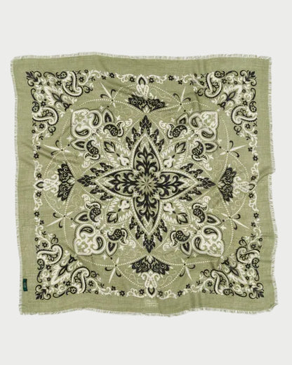 Green bandana with black and white pattern on a white background