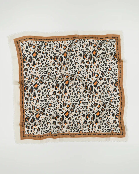 The Leo Scarf Beige by Maison Lecomte Flament is a square leopard wool scarf in black, beige, and brown with a brown border and dot details, shown laid flat on a white background.
