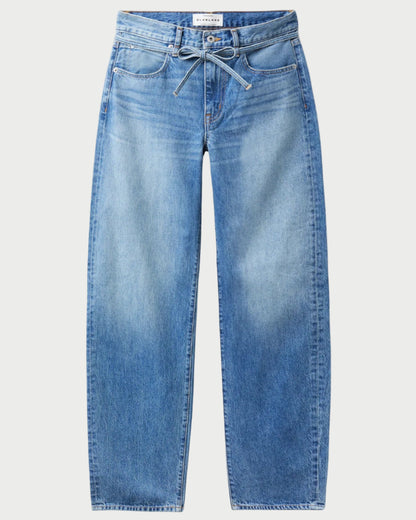 The SLVRLAKE Hailey Belted Curve Jean features a high-waisted, wide-leg silhouette in light indigo denim with front pockets and a drawstring tie at the waist for a relaxed fit.