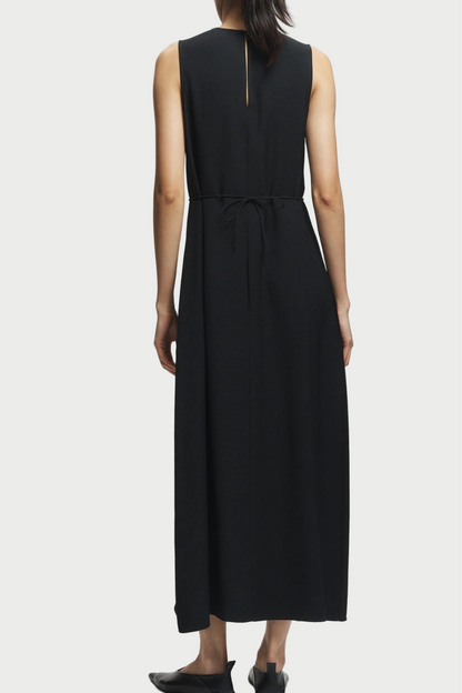 Black sleeveless dress worn by a person on a white background