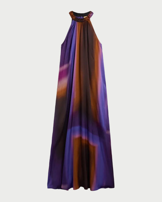 The Momoni Yuca Dress by Momoni is a sleeveless viscose satin maxi with a high neckline and flowing silhouette, featuring a vibrant abstract print in purple, blue, and orange.