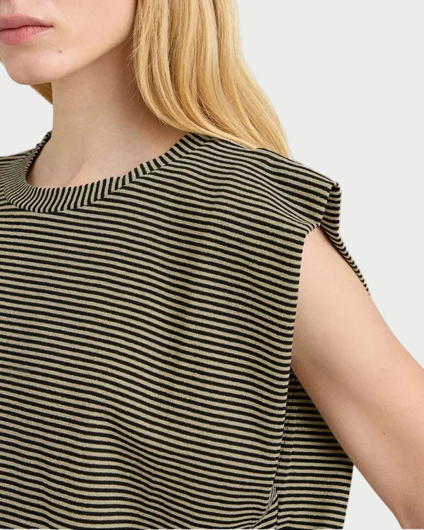 Woman wearing a black and beige striped sleeveless top against a white background