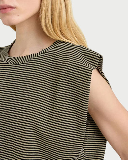 Woman wearing a black and beige striped sleeveless top against a white background