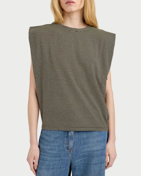 Woman wearing a sleeveless striped top and jeans on a white background