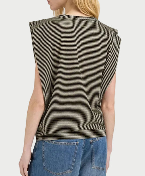 Person wearing a striped sleeveless top and blue jeans on a plain background