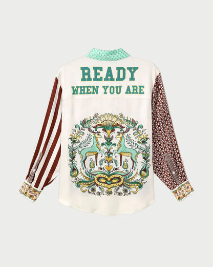 White shirt with decorative design and text on a gray background