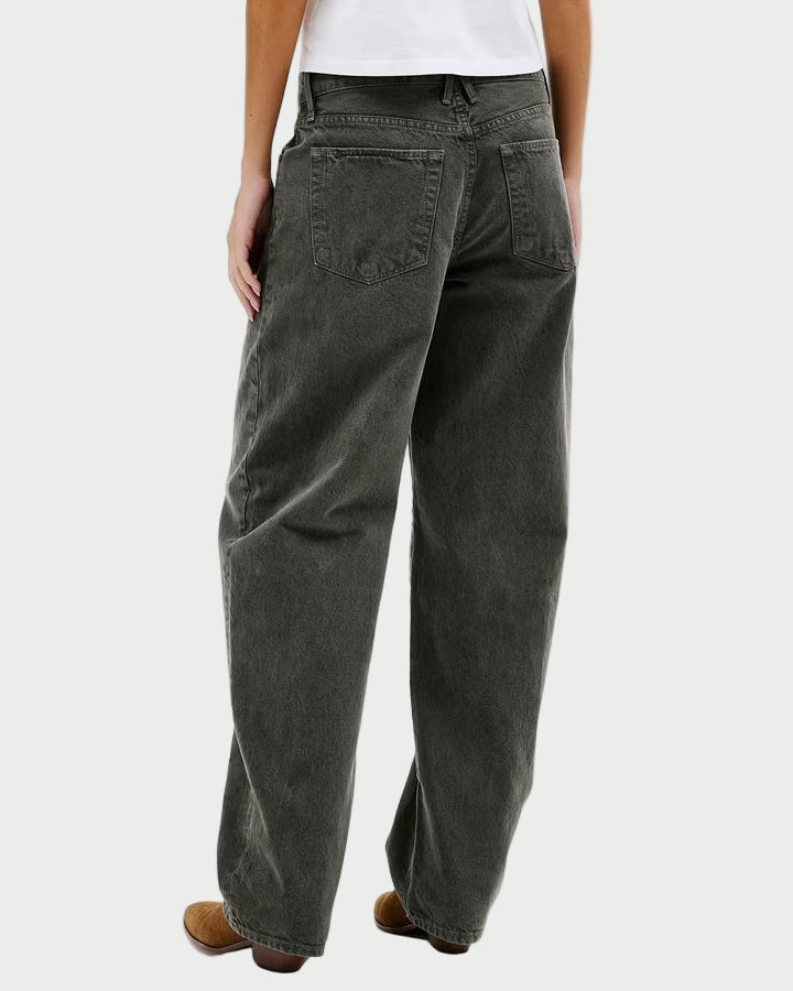 Person wearing dark gray pants and a white shirt on a white background