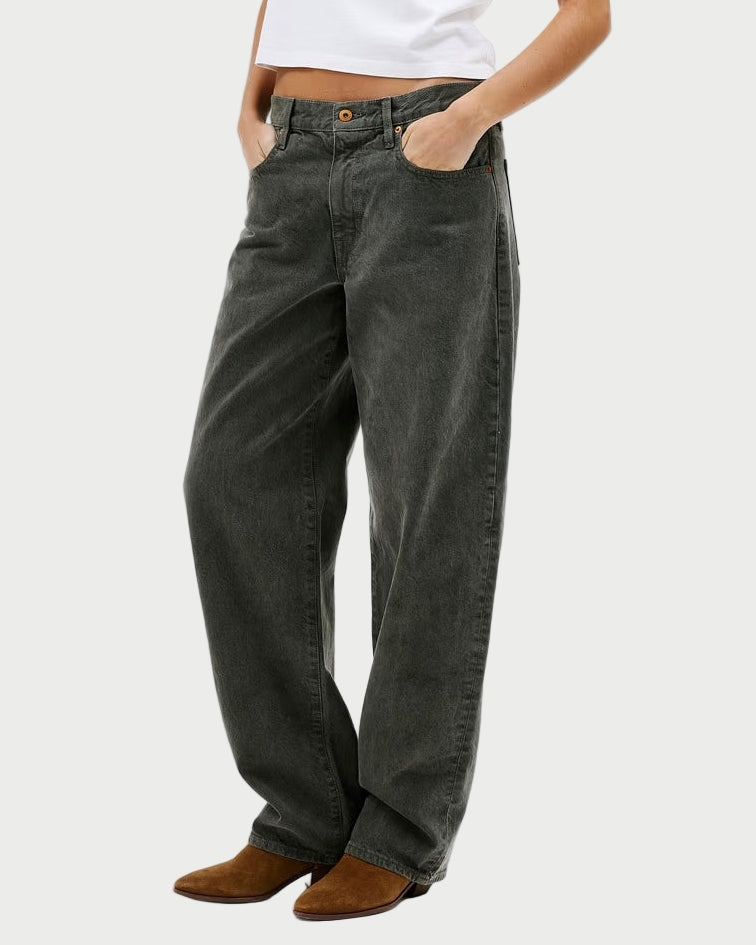 Woman wearing a white t-shirt and gray pants on a white background