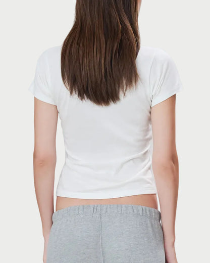 Person wearing a white t-shirt and gray pants on a plain background