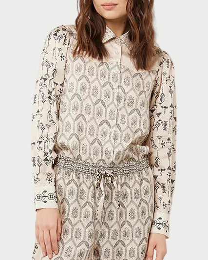 Woman wearing a patterned outfit on a white background