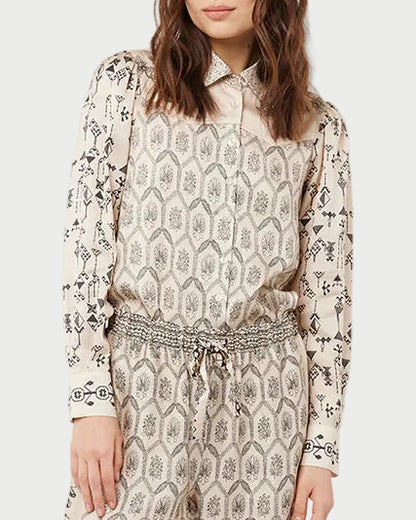 Woman wearing a patterned outfit on a white background