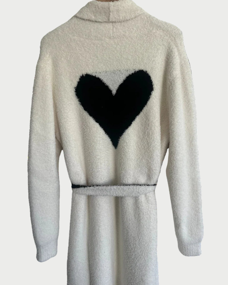 White robe with black heart design on the back against a white background