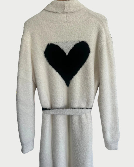 White robe with black heart design on the back against a white background