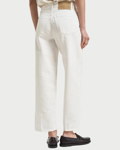 Person wearing white pants on a white background