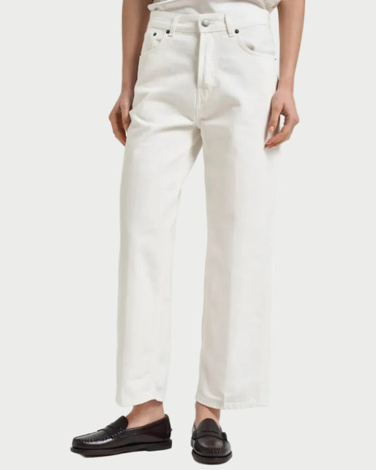 Person wearing white jeans and black shoes on a white background