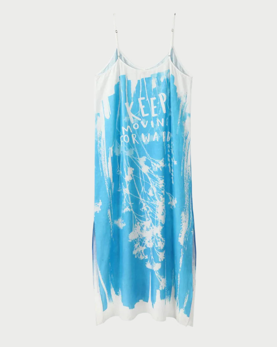 Blue and white tie-dye slip dress with 'Keep Moving Forward' text on a white background