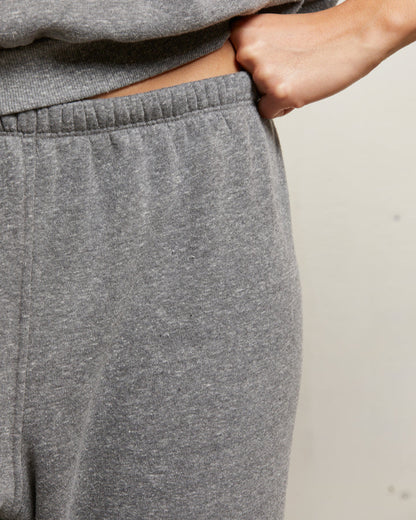 Gray sweatpants worn by a person with a neutral background