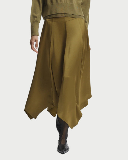 Person wearing a green outfit with a top and long skirt on a white background