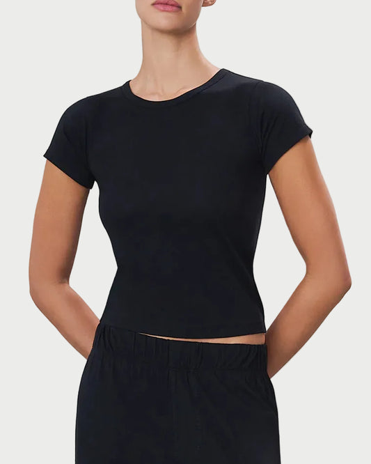 Woman wearing a black tee against a light gray background