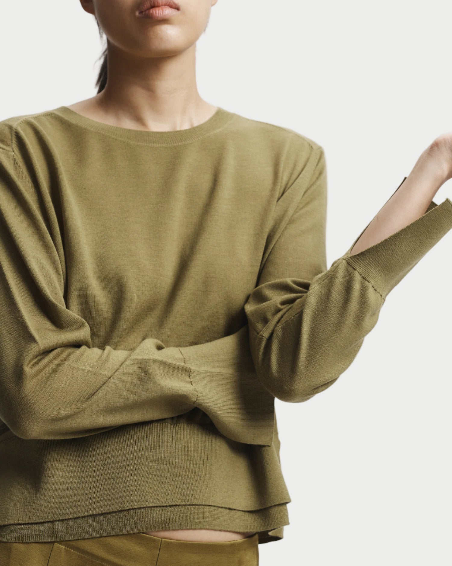 Person wearing a green outfit on a white background