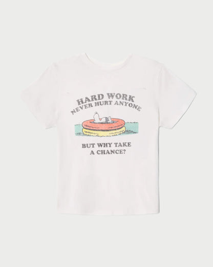 The RE/DONE Hard Work Snoopy Tee is a white shirt with a retro Peanuts graphic of Snoopy in a kiddie pool, text reading "HARD WORK NEVER HURT ANYONE" above and "BUT WHY TAKE A CHANCE?" below. Made from recycled heritage cotton.